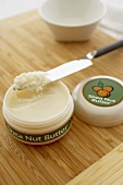Opened Container of Shea Nut Butter with Knife