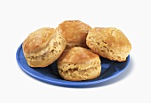 Four Biscuits on a Blue Plate, White Background