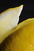 Close Up of Lemon Slice with Lemon on a Black Background
