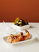 Two Jumbo Shrimp in a Small Dish; Dish of Mixed Olives