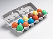 A Dozen Dyed Easter Eggs in Cardboard Egg Carton