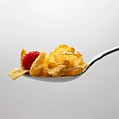 Spoonful of Cornflakes with a Raspberry, White Background