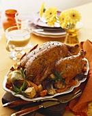 Whole Roast Turkey on a Platter with Roasted Vegetables, Carving Utensils, For Thanksgiving