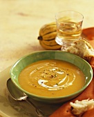 Bowl of Squash Soup, Spoon and Pieces of Crusty Bread