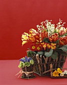 Two Flower Arrangements in Stick Baskets, On a Red Background