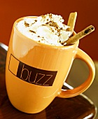 A Cup of Cinnamon Hot Chocolate with Cinnamon Sticks and Whipped Cream