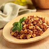Plate of Fusilli with Meat Sauce and a Basil Garnish