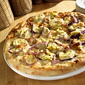 White Pizza Topped with Artichoke and Onions; Whole