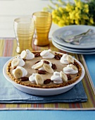 Butterscotch pie garnished with cream and pecans