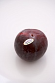 Organic Plum with Sticker on a White Background