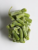 Cluster of Frozen Green Beans with Frost on a White Background