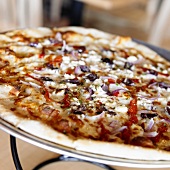 Close Up of Pizza Topped with Olives and Red Onion