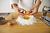 Making Pasta: Cracking Eggs into Flour