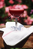 Cherry Beverage in a Stem Glass with Cherry Garnish; Outdoors