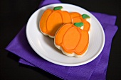 Three pumpkin biscuits for Halloween on a plate
