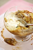 Partially Eaten Bowl of Baked Bananas with Vanilla Ice Cream, Spoon