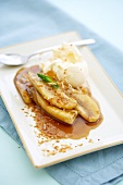 Baked Bananas with a Scoop of Vanilla Ice Cream on a Plate