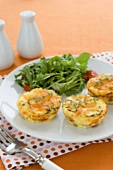 Three Crustless Mini Quiches on a Plate with a Side Salad