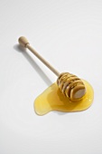 Honey Dipper with Honey on a White Background