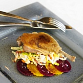 Duck Leg Over Coleslaw with Sliced Red and Yellow Beets