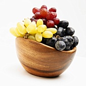 Purple, Red and Green Grapes in a Wooden Bowl