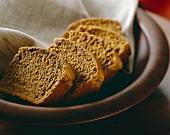 Slices of Annadamma Bread in a Wooden Bowl