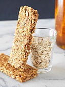 Two Granola Bars with Measuring Cup of Oats