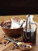 A bottle of coffee & vanilla liqueur with coffee beans & sugar