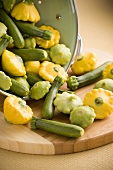 Assorted Baby Squash Spilling From a Colander; Patty Pan and Courgettes