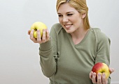 Woman Holding Two Apples