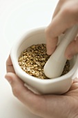 Crushing Fennel Seeds in a Mortar and Pestle
