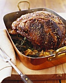 Beef Roast in Roasting Pan with Herbs and Onions
