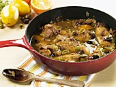 Guinea fowl ragout with olives in a frying pan