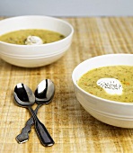 Two Bowls of Asparagus Soup with Sour Cream and Dill