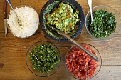 Bowl of Guacamole with Bowls of Ingredients