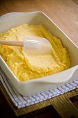 Spreading Polenta in a Baking Dish with Rubber Spatula