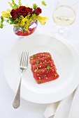 Slices of Raw Tuna and Watermelon Layered on a Plate