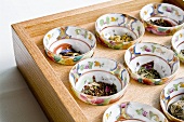 Bowls of Extotic Tea Leaves on Wooden Tray