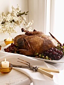 Whole Roast Duck with Fruit on Platter; Carving Set