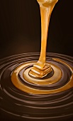Caramel sauce pouring into swirled chocolate