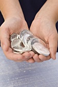 Childs Hands Holding Silver Chocolate Gelt; Chanukah Coins