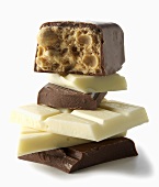 Various Pieces of Chocolate; Stacked on White Background