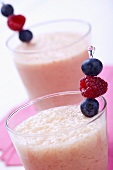 Raspberry Smoothies Garnished with Fresh Raspberries and Blueberries