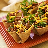 Mini Taco Bowls with Sausage Filling; Lettuce and Cheese