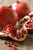 Piece of Pomegranate with Seeds; Whole Pomegranates