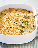Spoon Scooping Broccoli Rice Casserole from Baking Dish