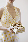 Woman Holding a Box of Homemade Dog Cookies