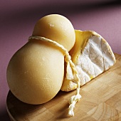 Provolone and St. Andre Cheese on Cutting Board