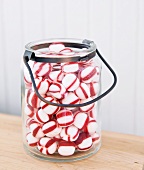 Red and White Peppermint Candies in a Jar