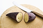 Halved Purple Pepino on a Cutting Board